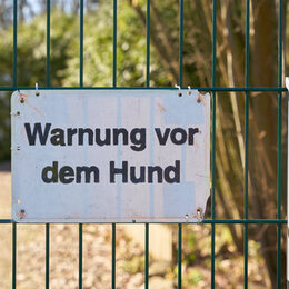 Ein Schild mit der Aufschrift "Warnung vor dem Hund"