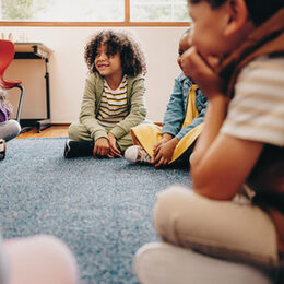 Group of children sitting in a circle in