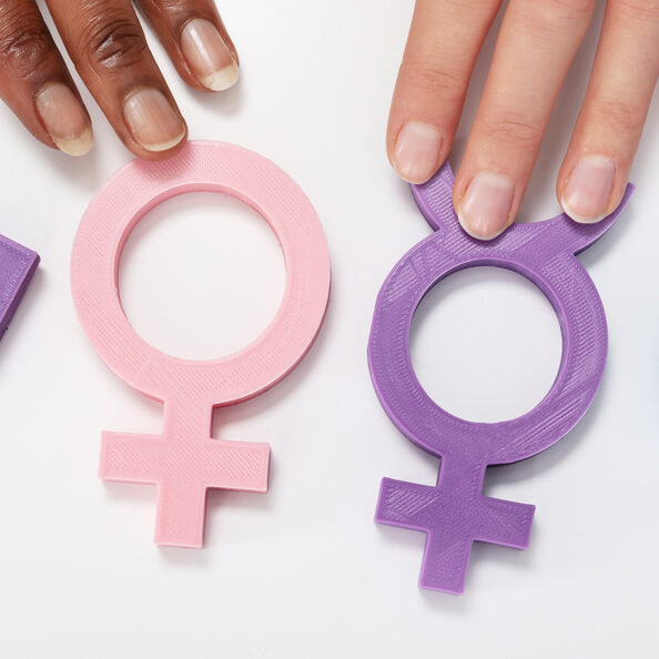 An Overhead View Of Multiethnic People Holding Different Type Of Gender Sign On White Table