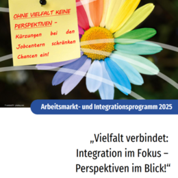 Coverbild AMIP 2025: Bunte Blume mit Post-It mit der Aufschrift "Ohne Vielfalt keine Perspektiven - Kürzungen bei den Jobcentern schränken Chancen ein!"