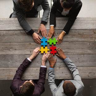 Business people assembling jigsaw puzzle