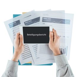 Businessman working at office desk with financial reports and using a touch screen tablet, hands close up, top view