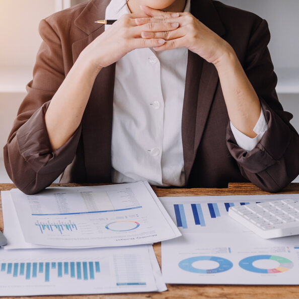 Close up bookkeepers working with balance sheet to analyze problems and find solutions to bringing develop business organization and company's stock market system. Common stock and preferred stock.