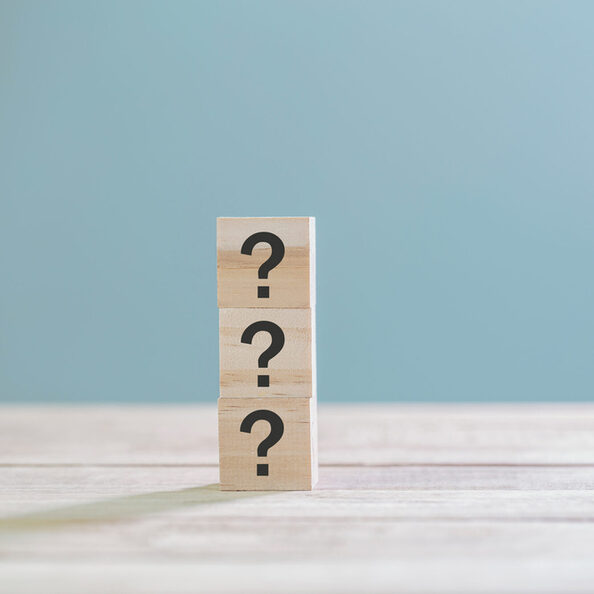 Wooden cube block with sign question mark symbol on wood table w