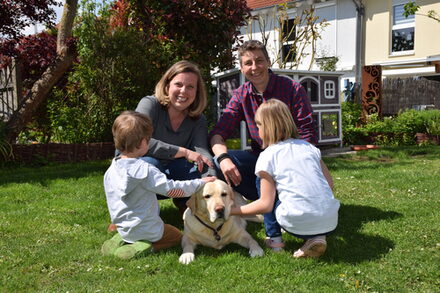 Familie Hacken mit ihrem Hund im Garten