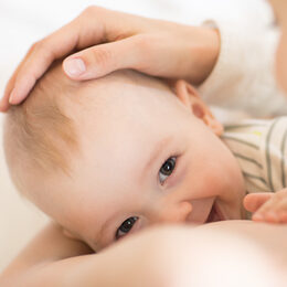 Picture of baby feeds mom's breast