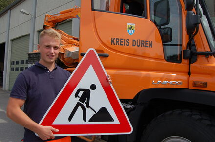 Leon Faust mit Straßenschild