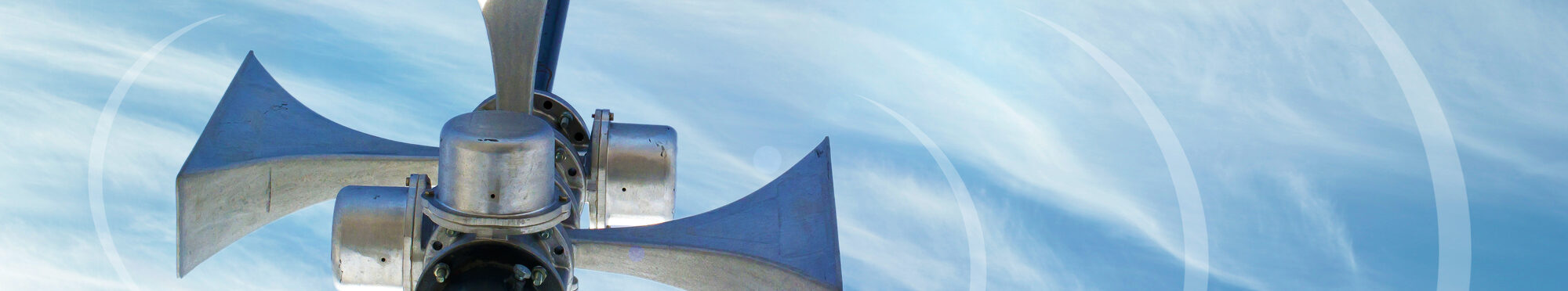 Outdoor loudspeaker against the background of blue sky, sound waves.