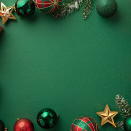 Christmas Eve concept. Top view photo of gift boxes with ribbon bows green red baubles gold star ornaments and pine branches on isolated green background with copyspace in the middle