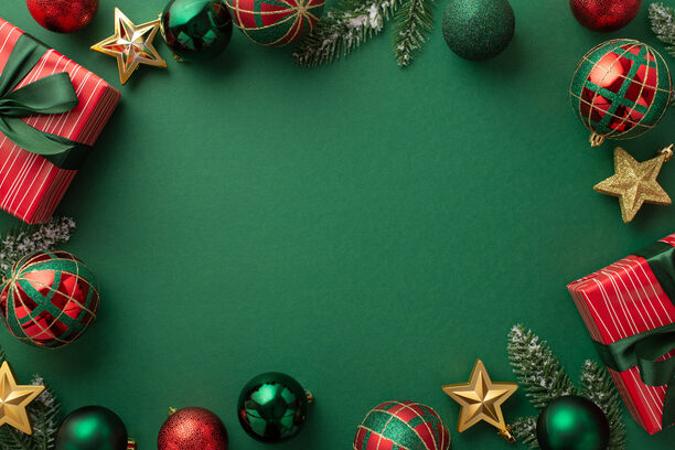 Christmas Eve concept. Top view photo of gift boxes with ribbon bows green red baubles gold star ornaments and pine branches on isolated green background with copyspace in the middle