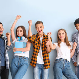 Portrait of happy young students on color background