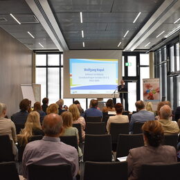 Wolfgang Kopal vom Ministerium für Arbeit, Gesundheit und Soziales des Landes Nordrhein-Westfalen (Bühne) sprach beim Kick-Off zur Sozialplanung über das Ziel, den ersten Sozialplan für den Kreis Düren aufzubauen, wodurch Chancengleichheit für alle Bürgerinnen und Bürger aktiv gefördert werden soll.