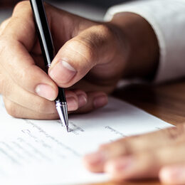 Businessman signing a document in office