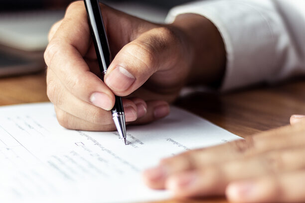 Businessman signing a document in office