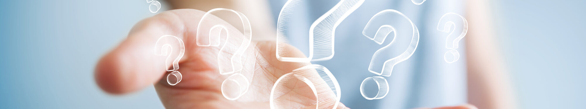 Businessman holding hand drawn question marks