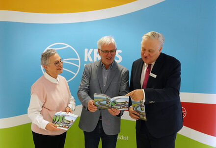 Landrat mit Marlene und Norbert Dreßen, wie sie sich den Freizeitführer anschauen.