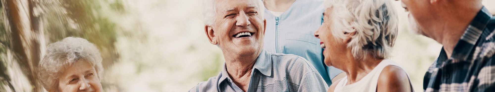 Happy elderly man with walking stick and smiling senior people r